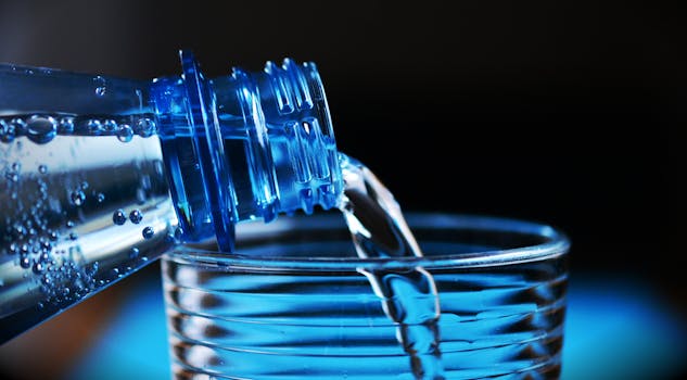 a water bottle and fruits for hydration